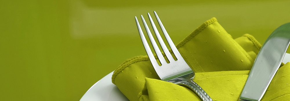 Green table and napkin with silverware