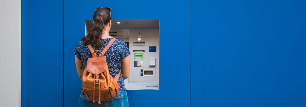 Woman taking money from ATM